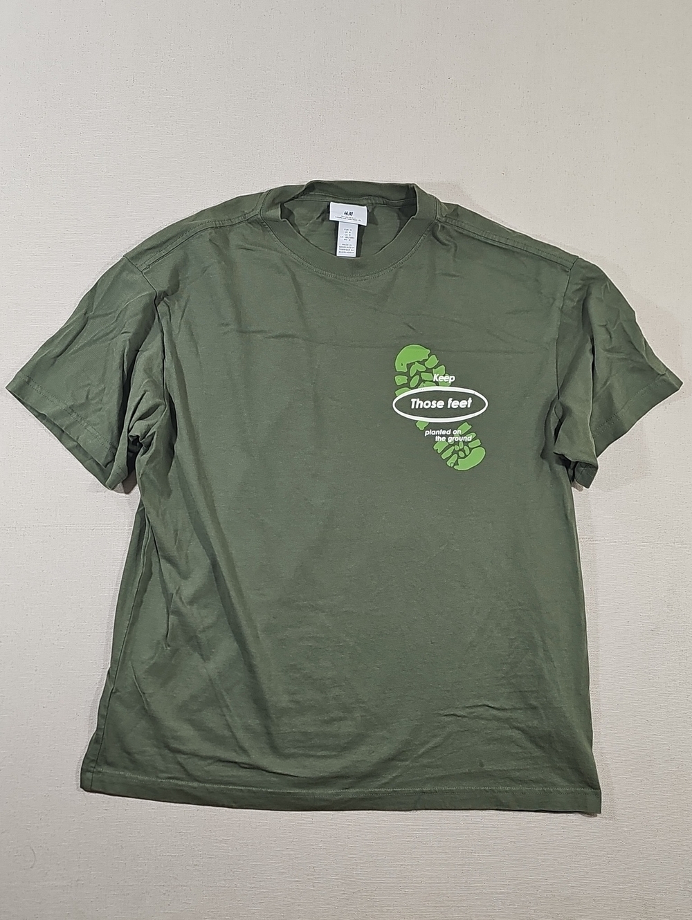 H&M Olive Green Short Sleeve Tee with Bright Green Footprint Graphic